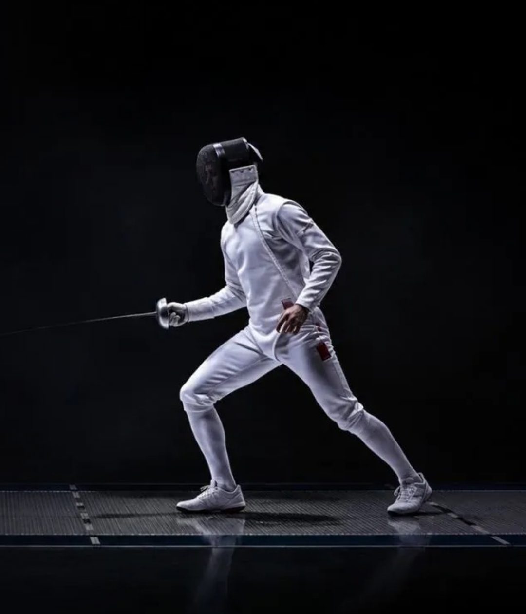 A fencer in white in a deep lunge against a dark background